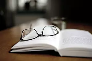 pair of glasses on an open book