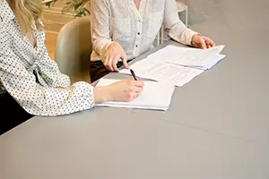 two women going over paperwork